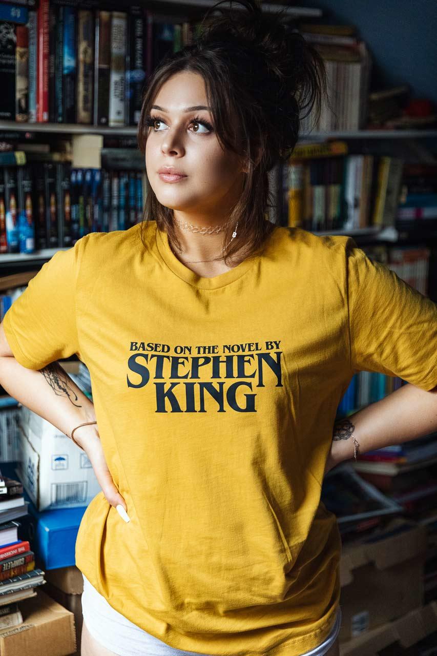 @bunnie.models wearing Based on the novel by Stephen Kind T-shirt in mustard yellow