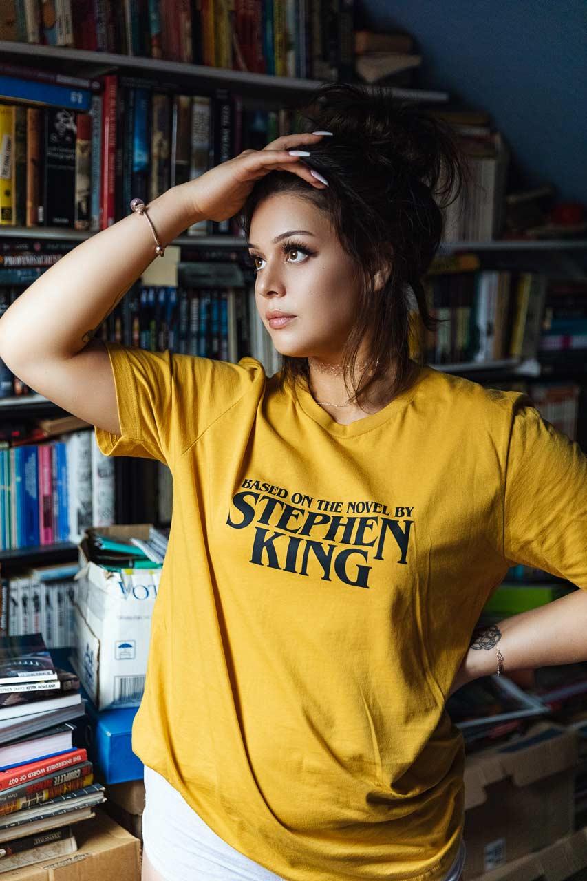 @bunnie.models wearing Based on the novel by Stephen Kind T-shirt in mustard yellow