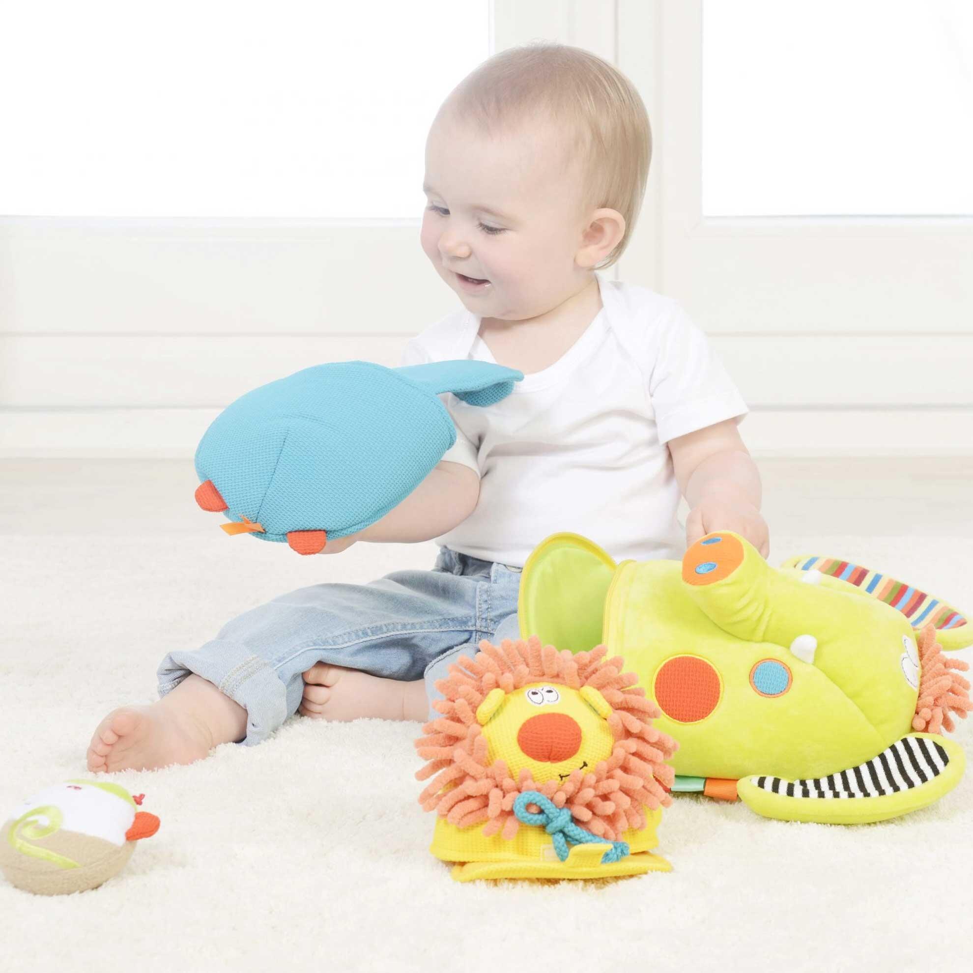 Baby playing with hippo toy