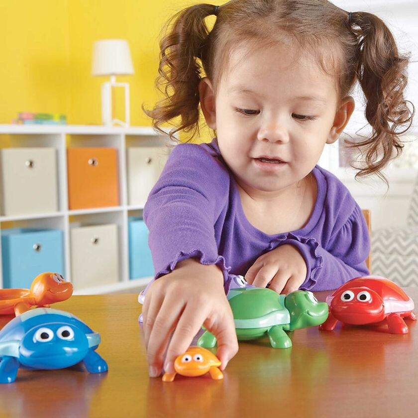 Little Girl Having Fun With Snap n Learn Number Turtles