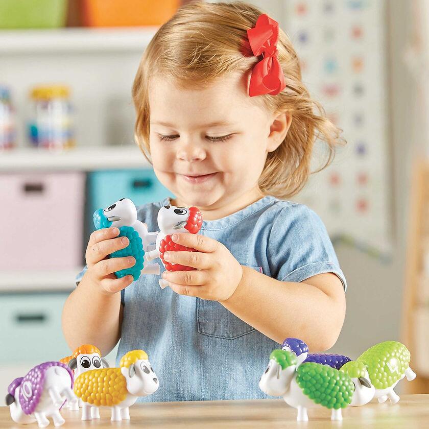 Little Girl Playing With Snap N Learn Counting Sheep