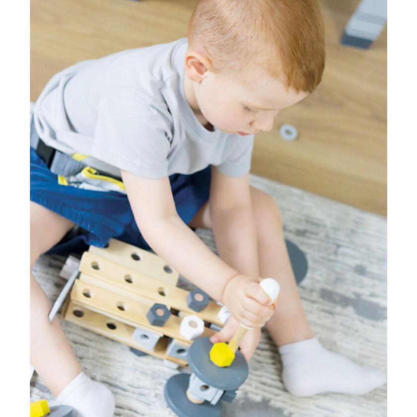 Little Boy Playing With Small Foot Wooden Construction Set "Miniwob"