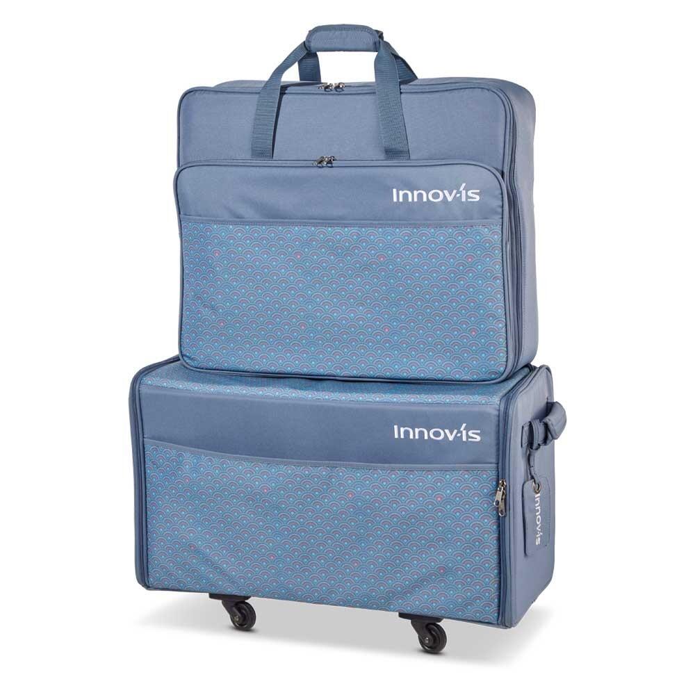 Blue trolley bag set on wheels. Embroidery unit bag on top of the machine bag