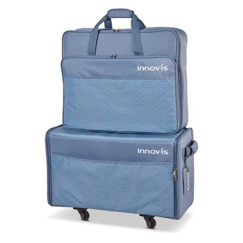 Blue trolley bag set on wheels. Embroidery unit bag on top of the machine bag