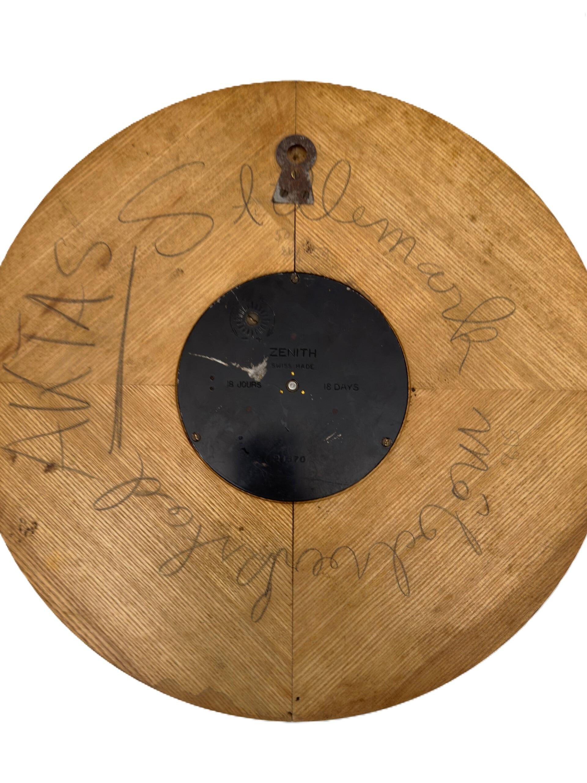 Turned wooden shield shaped wall clock with Roman numerals rear image