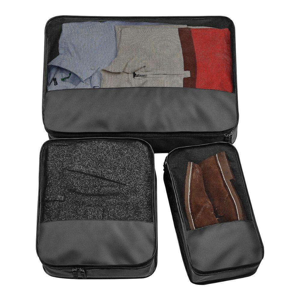 Three black BG459 packing cubes from Bagbase, each containing neatly folded clothes, displayed on a white background.