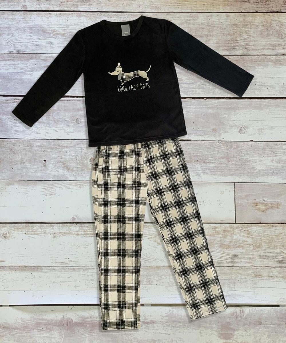 A long-sleeve black shirt featuring a dog and the text "Long, Lazy Days," paired with black and white plaid pants, laid out on a wooden surface. This ensemble is from the HL219 collection by Home & Living.