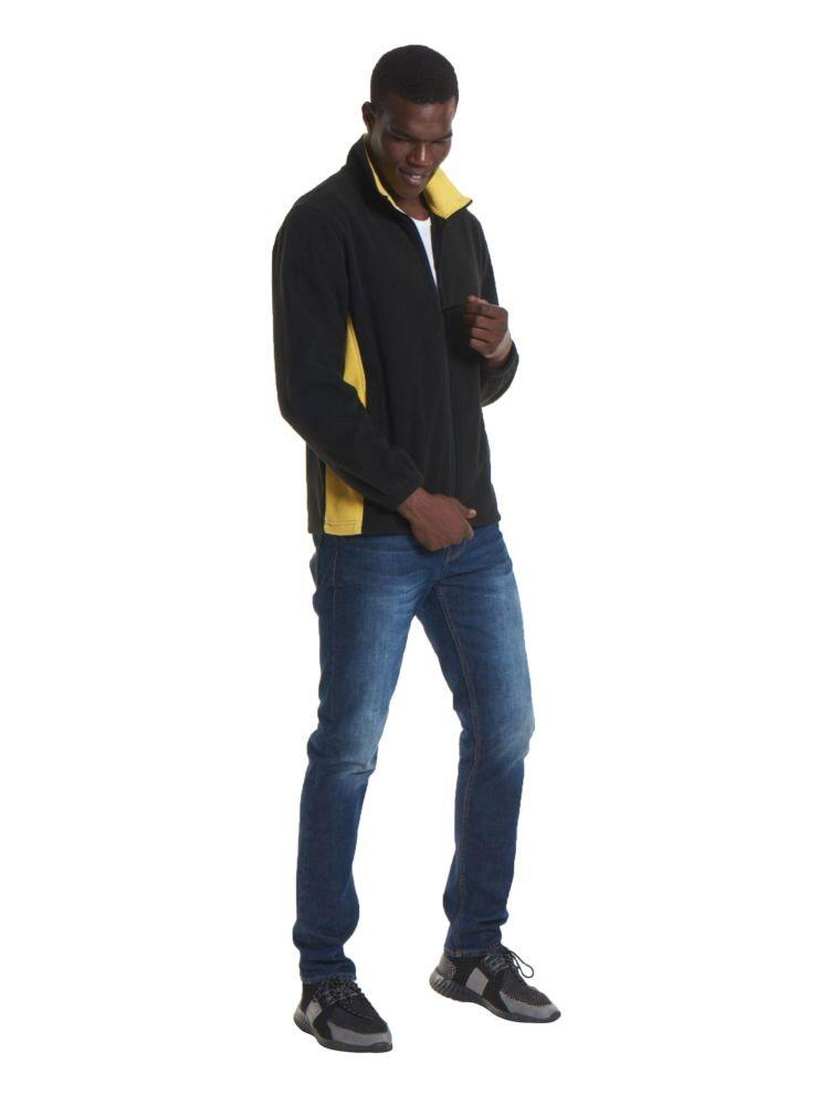 A man wearing a Uneek Two Tone Full Zip Fleece Jacket in Black & Yellow and Blue jeans on a white background