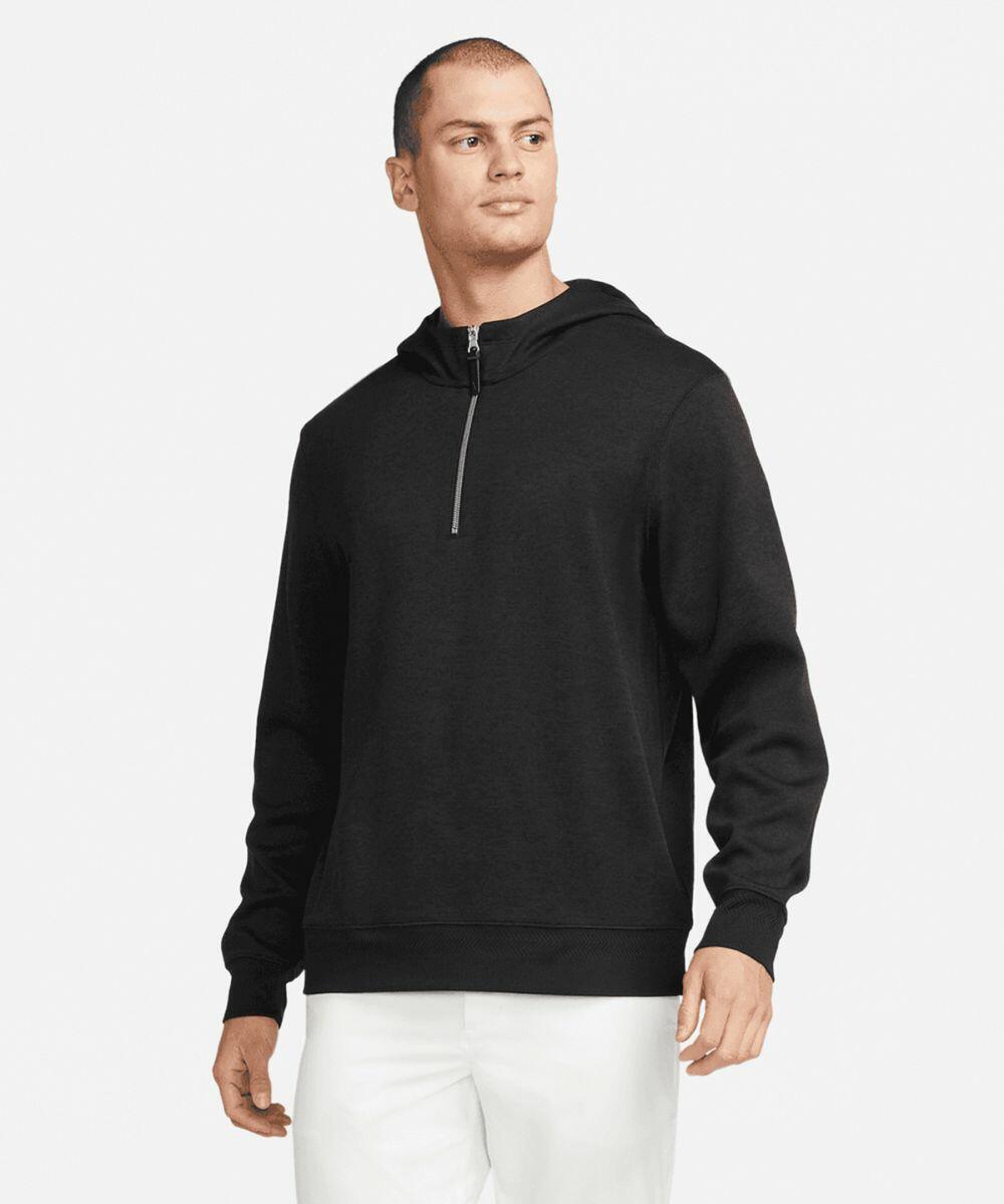 A person wearing a black Nike NK357 long-sleeve zip-up hoodie and white pants stands looking slightly to the side.