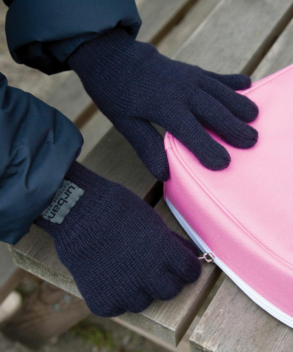 Person wearing black gloves and a dark jacket, holding a pink R147J from Result while sitting on a wooden bench.