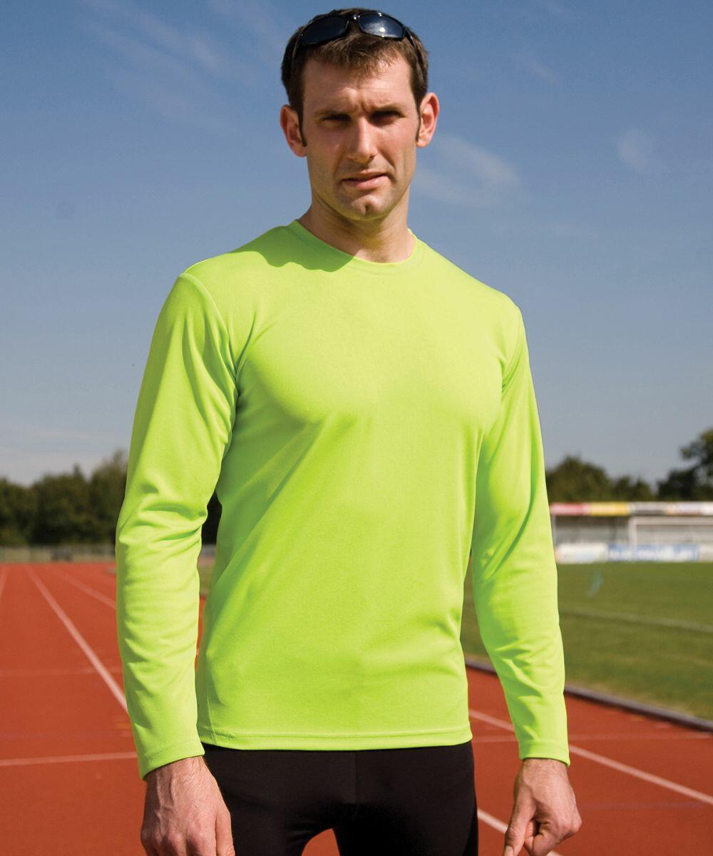 A man in a bright yellow-green long-sleeve Spiro S254M shirt stands on a running track.