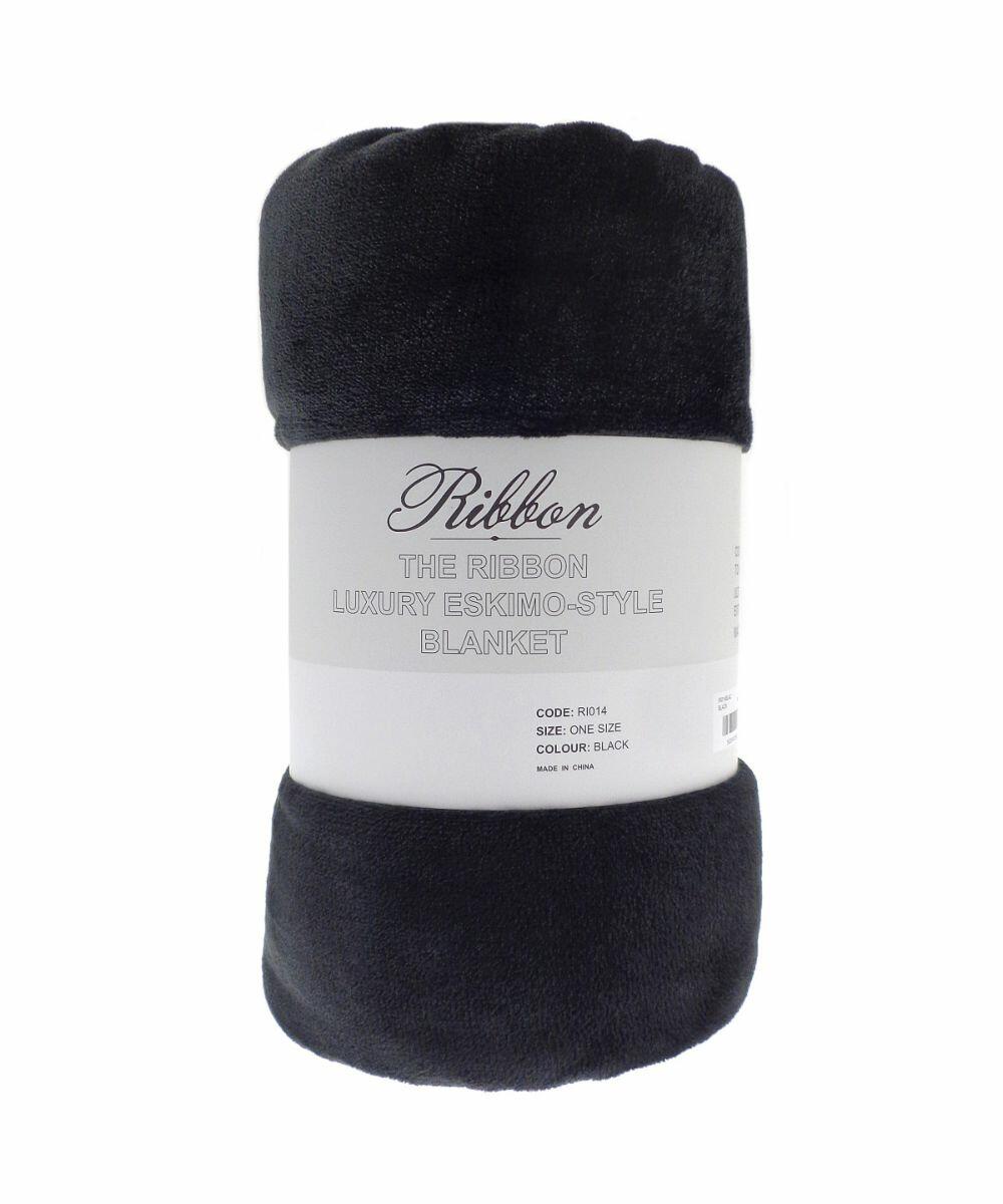A rolled, dark gray luxury blanket featuring a label with "The Ribbon Luxury Eskimo-Style Blanket, Code: RI014, Size: One Size, Color: Black," made in China.