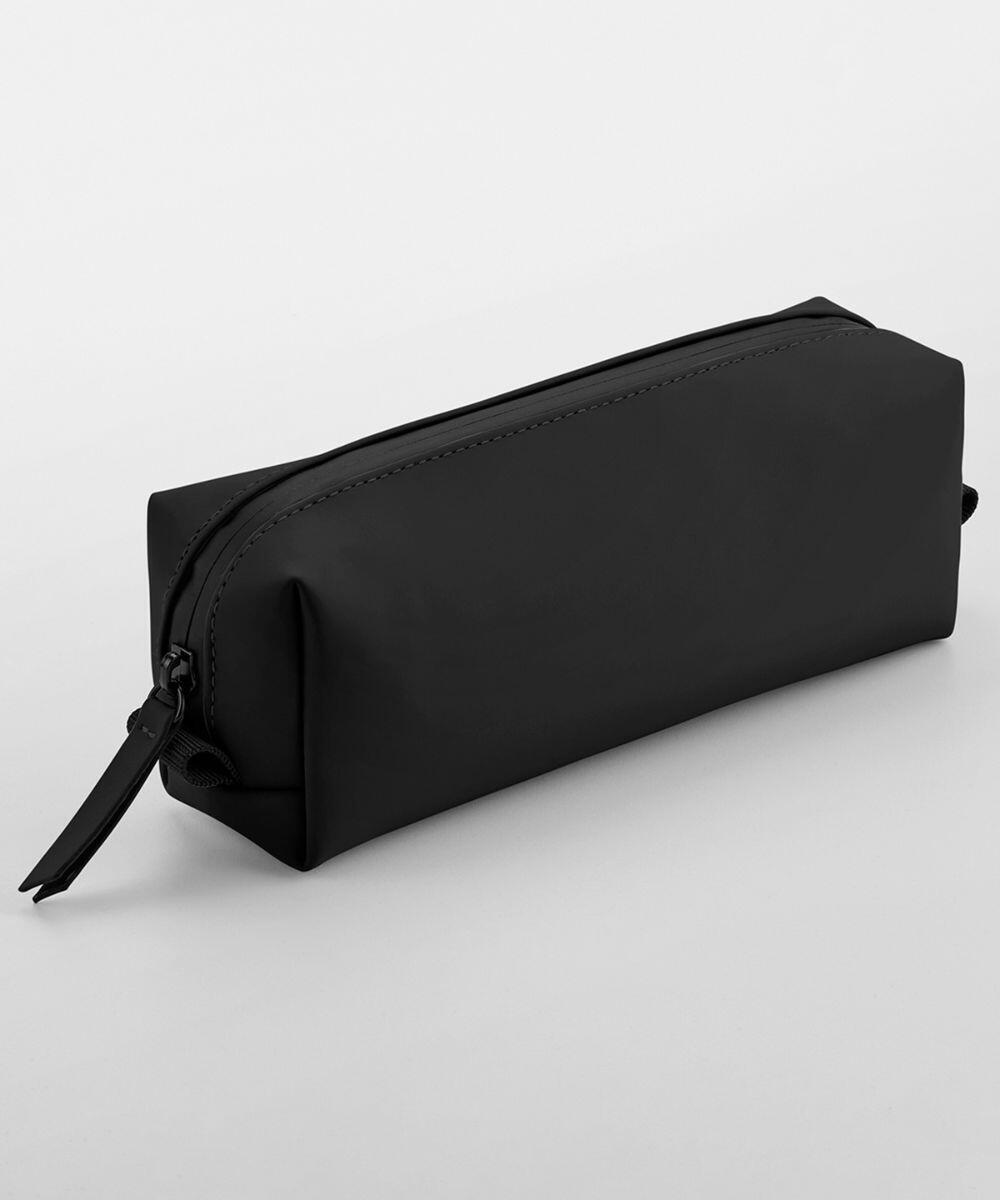 A sleek, rectangular black Bagbase BG329 with a zipper closure. The material appears to be smooth and slightly reflective, giving it a modern and minimalist look. It is photographed against a plain white background.