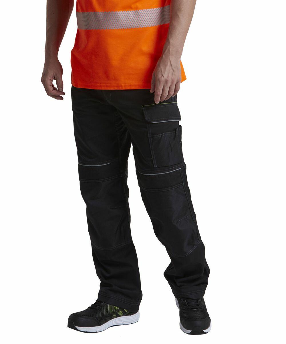 A person standing wears black cargo pants, black sneakers, and an orange high-visibility shirt with reflective stripes from the Portwest PW364.