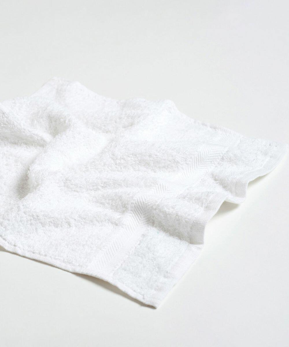 A white, neatly folded Towel City TC001 with a textured surface lies on a plain, light-colored background.