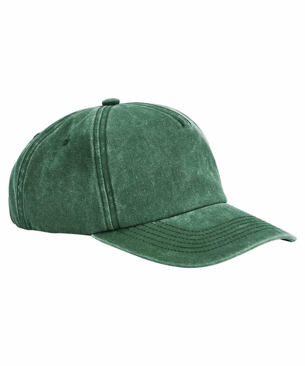 A green, worn-look Beechfield BC657 baseball cap with a curved brim and stitched vent holes. The cap has visible seam lines running from front to back and around the brim. The texture appears soft and slightly faded, giving it a vintage appearance.