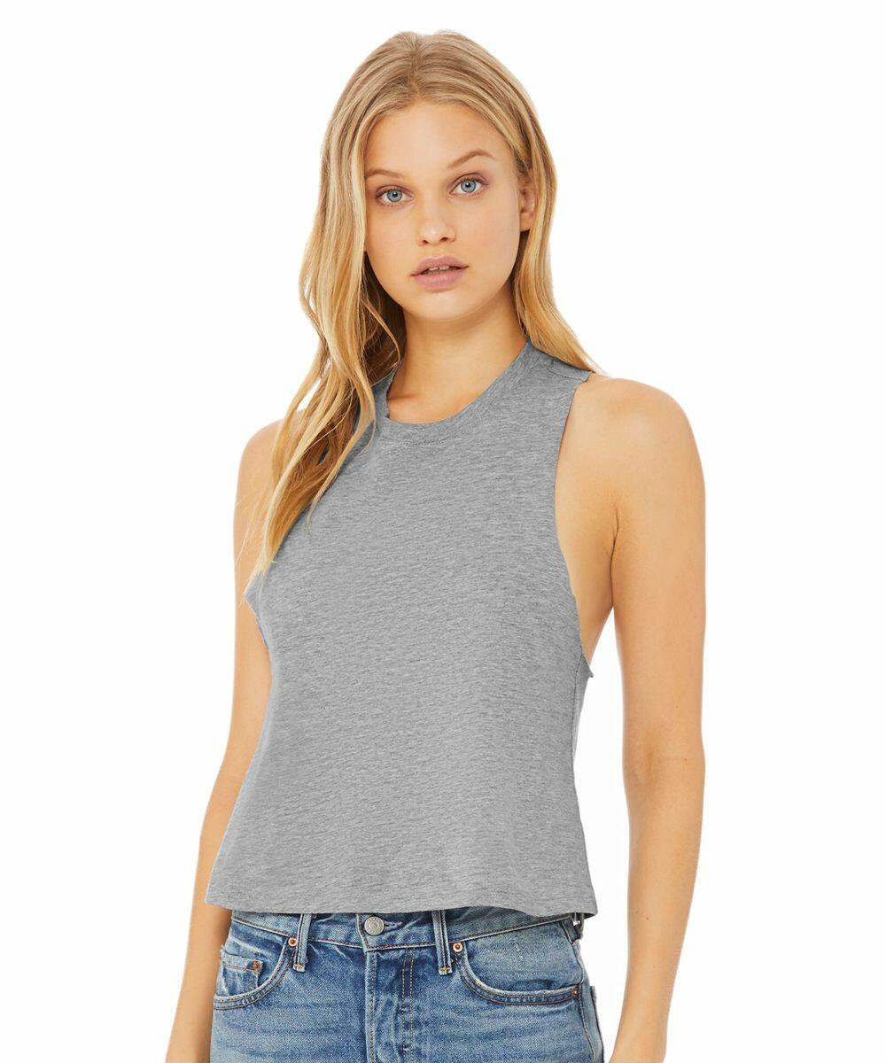A woman with long blonde hair is wearing a sleeveless, gray Bella Canvas BE127 tank top and blue jeans. She is standing against a plain white background, gazing directly at the camera with a neutral expression.