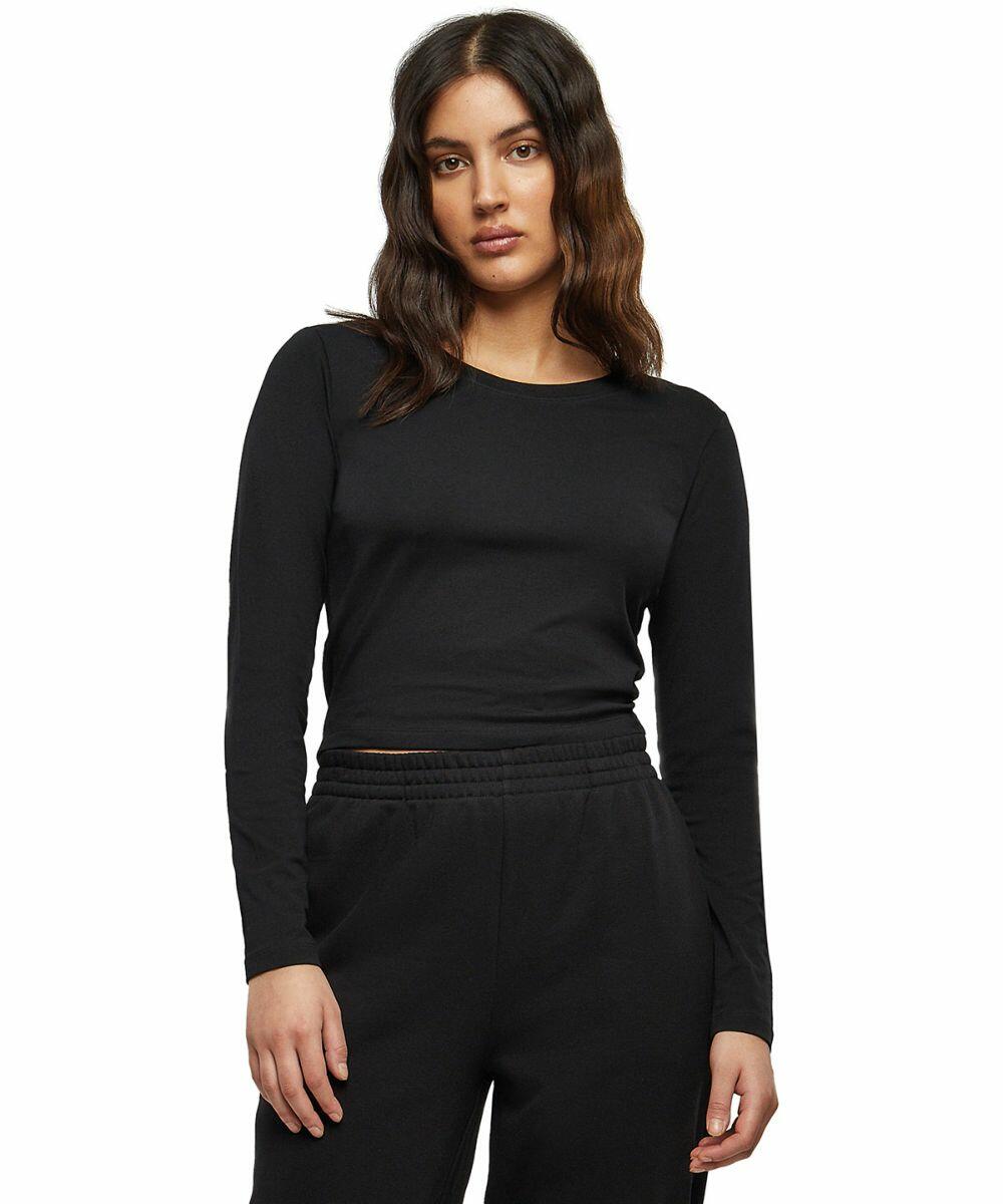 A person with long wavy hair wearing a black BY261 top and black pants from Build Your Brand stands against a plain white background.