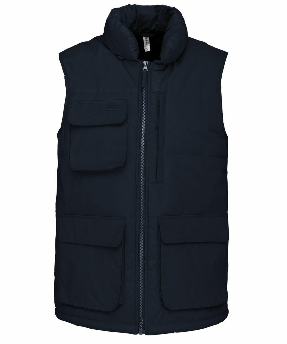 A navy blue sleeveless puffer vest with multiple front pockets and a zip-up closure, the Kariban KB615.