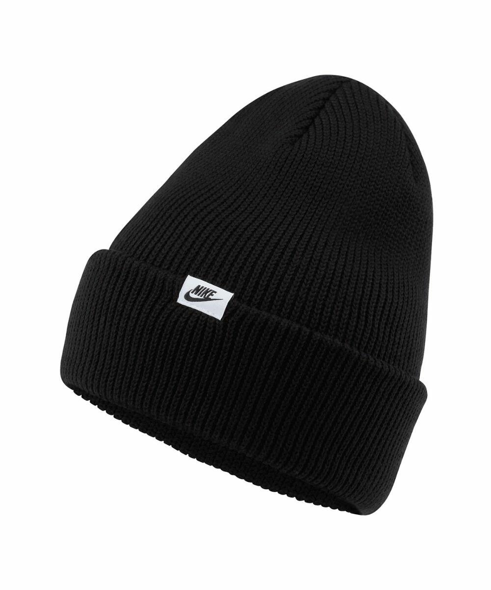 A black knitted beanie with a folded brim and a small white Nike logo patch on the front, known as the NK358 by Nike.