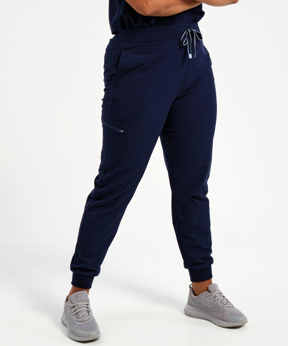 Person wearing Onna NN610 navy joggers with a drawstring waist, pockets, and light gray sneakers, standing against a plain white background.