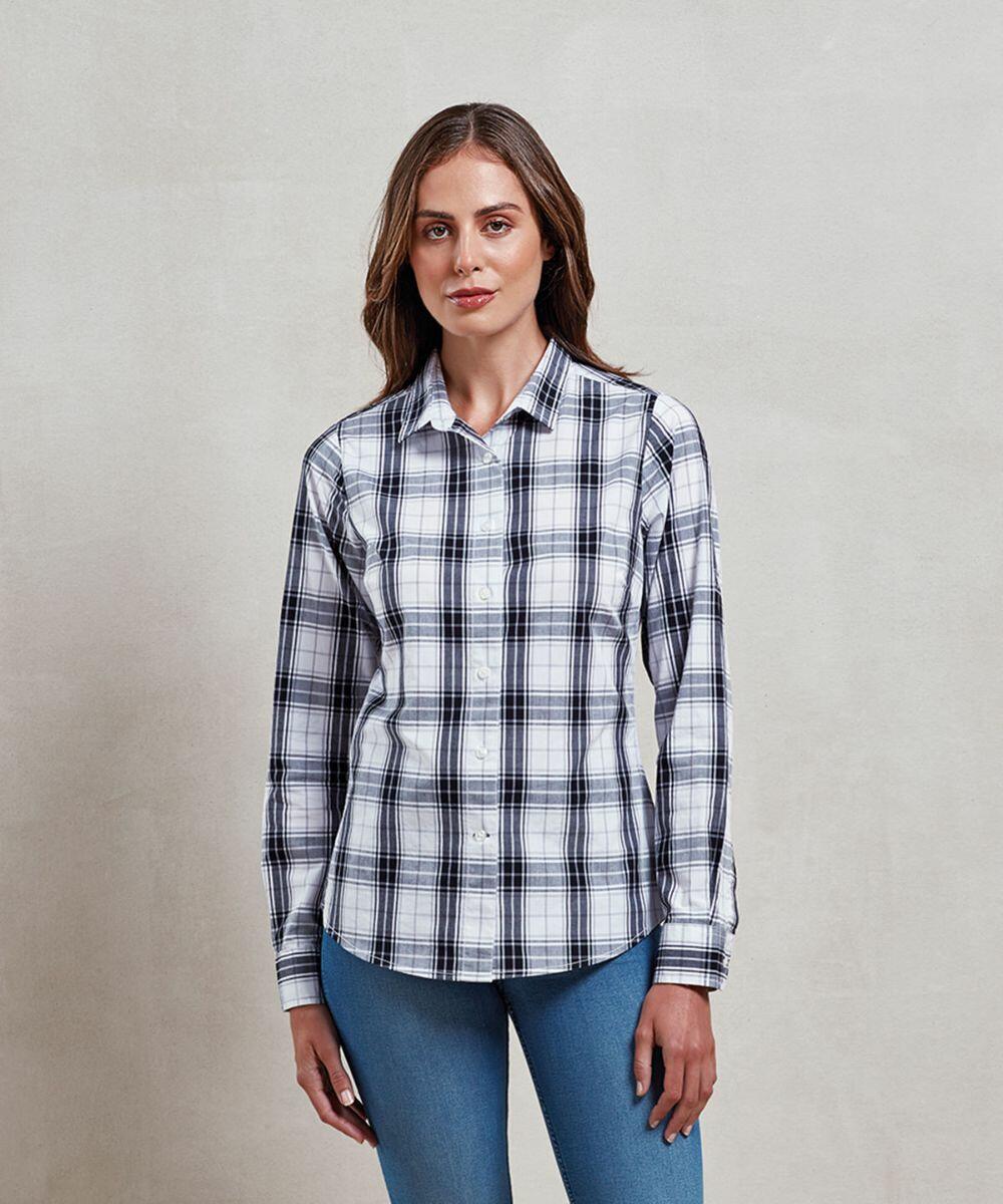A person in a plaid button-up shirt and blue jeans stands against a plain, neutral background, showcasing the PR354 from Premier.
