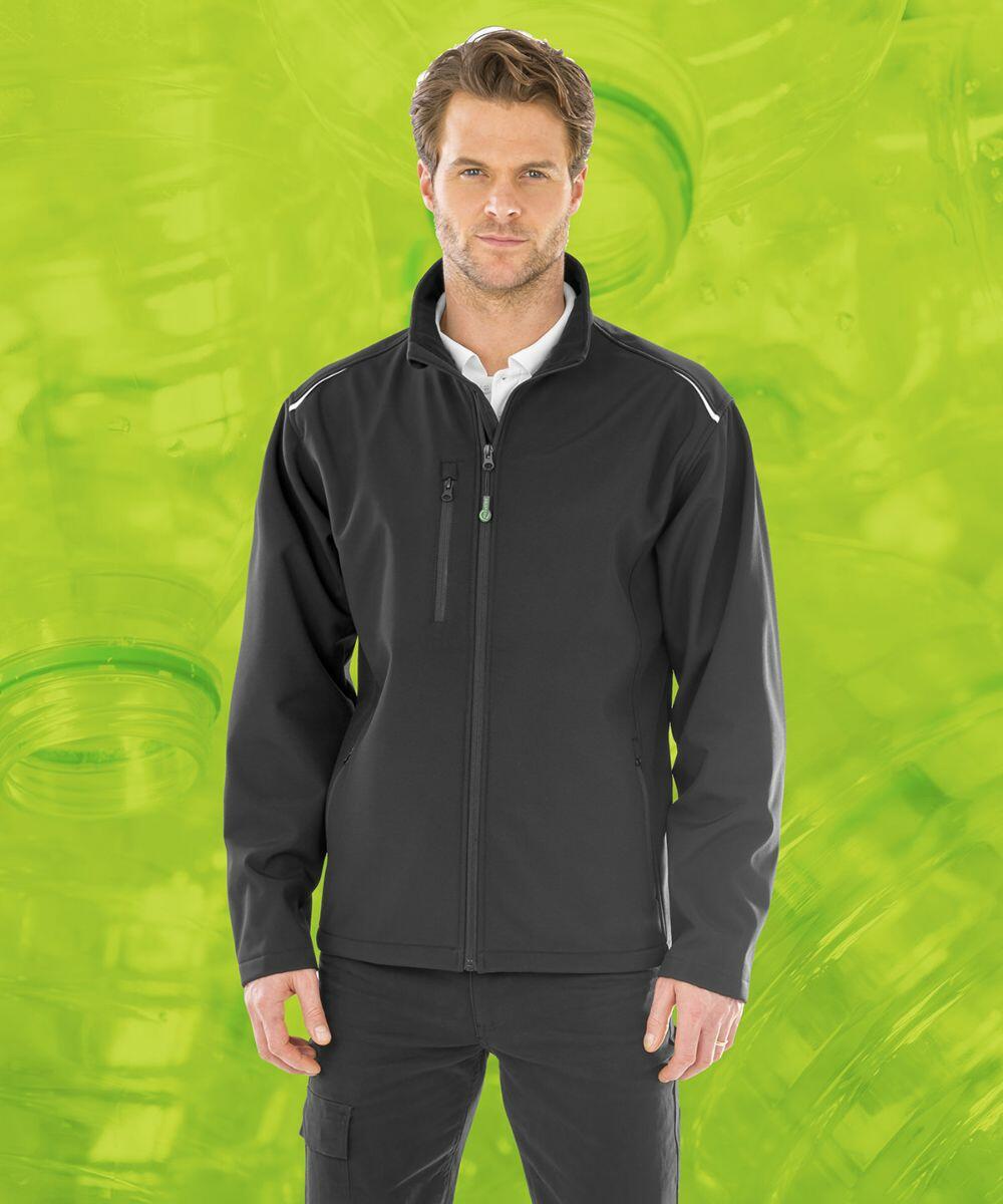 A man wearing a Result R900X and black pants stands against a lime green background with a pattern of plastic bottles.