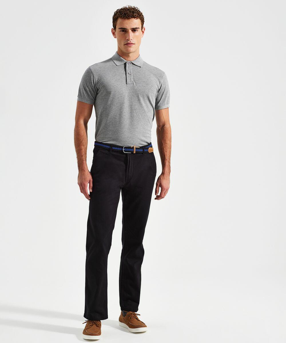 A person stands against a plain background wearing an Asquith & Fox AQ050 short-sleeve gray polo shirt, black pants with a belt, and brown shoes.