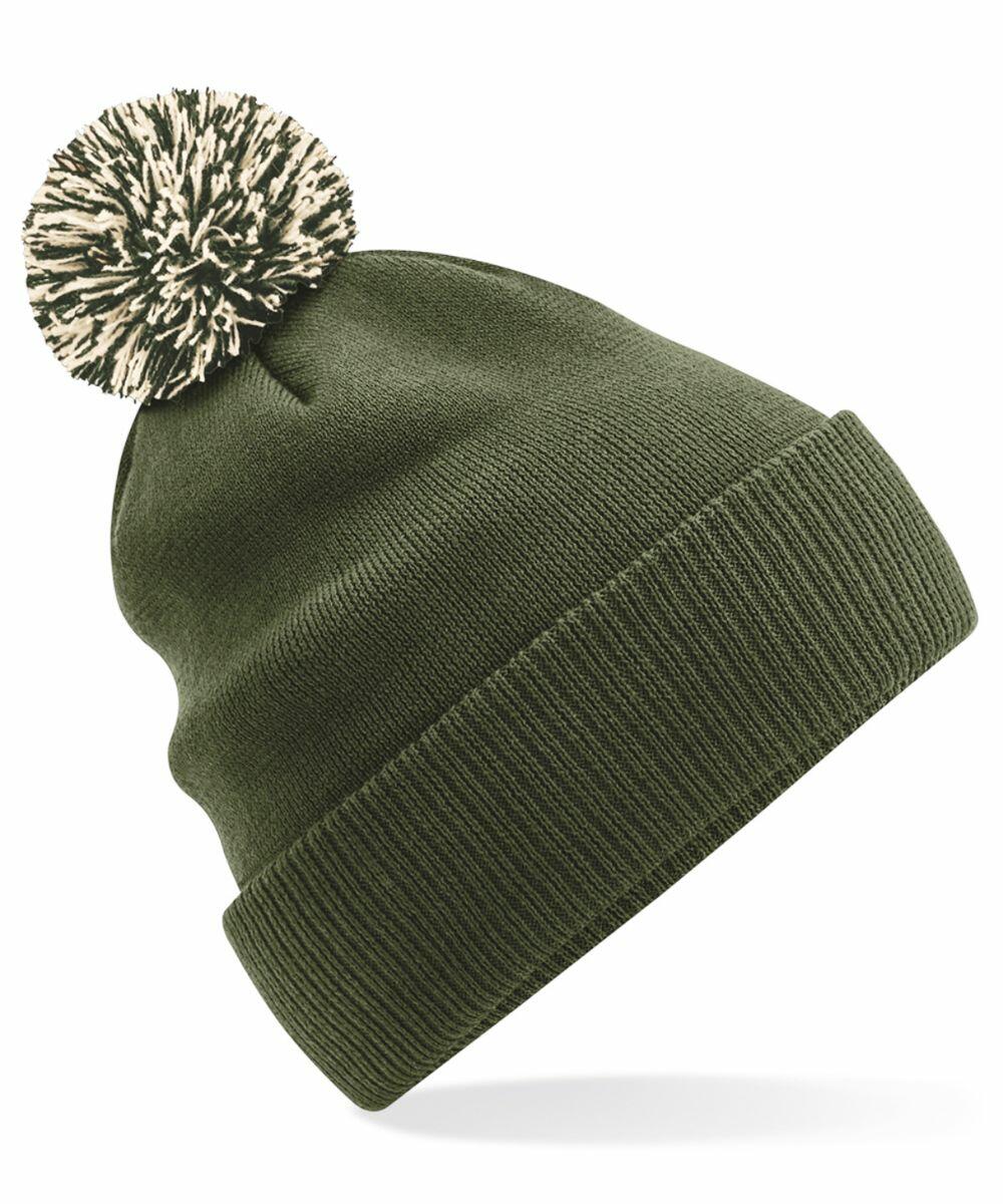 The Beechfield BC450 is a green knit beanie, accentuated with a large, fluffy pom-pom in black and white. It features a folded cuff for added warmth and style. The white background accentuates the texture and vibrant color of the beanie.