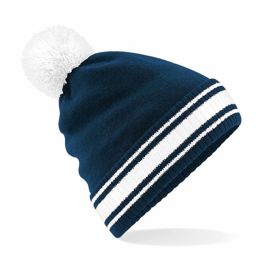 A Beechfield BC472 knit beanie in blue and white, adorned with a large white pom-pom on top. It showcases two white stripes near the edge and is displayed against a plain white background.