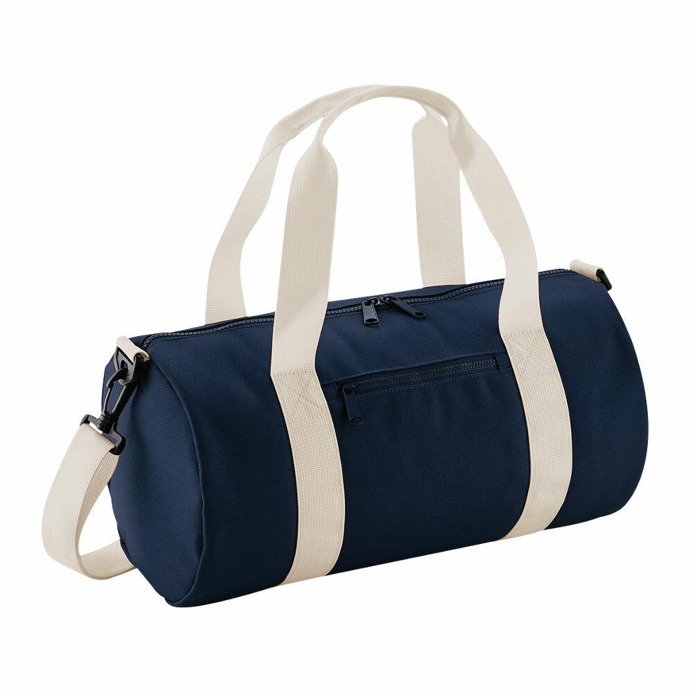 The Bagbase B140S is a navy blue duffel bag with cream-colored straps and a convenient shoulder strap. It includes a zippered pocket on the front and a main zippered compartment on the top.