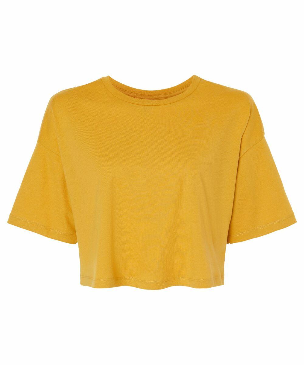 The BE137 by Bella + Canvas is a plain mustard yellow short-sleeve crop top set against a white background. It features a round neckline, loose fit, and slightly dropped shoulders for a relaxed look.