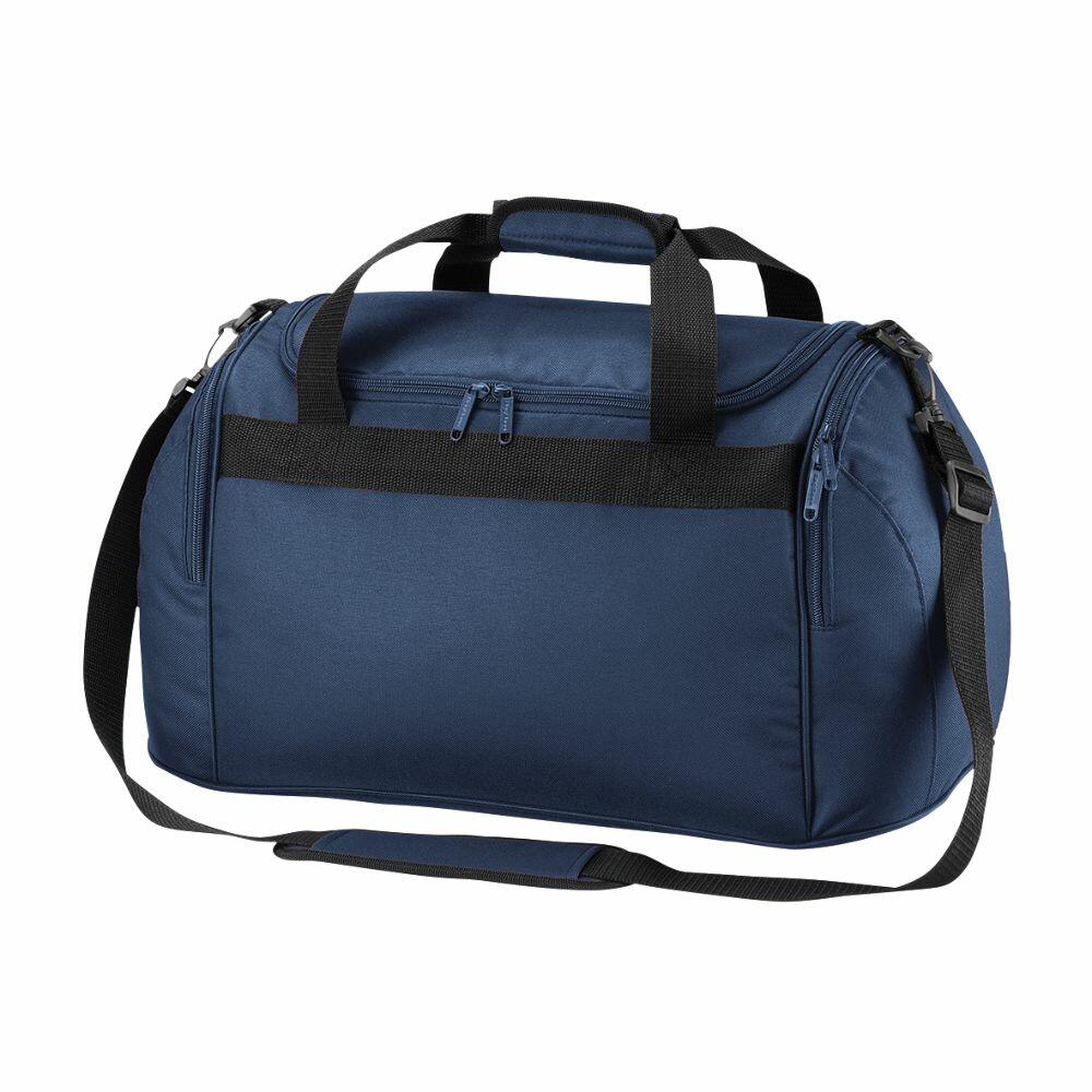 Standing upright against a white background, the Bagbase BG200 features a blue body with black straps and zippers, includes a main compartment, a front zipper pocket, and comes with an adjustable shoulder strap.
