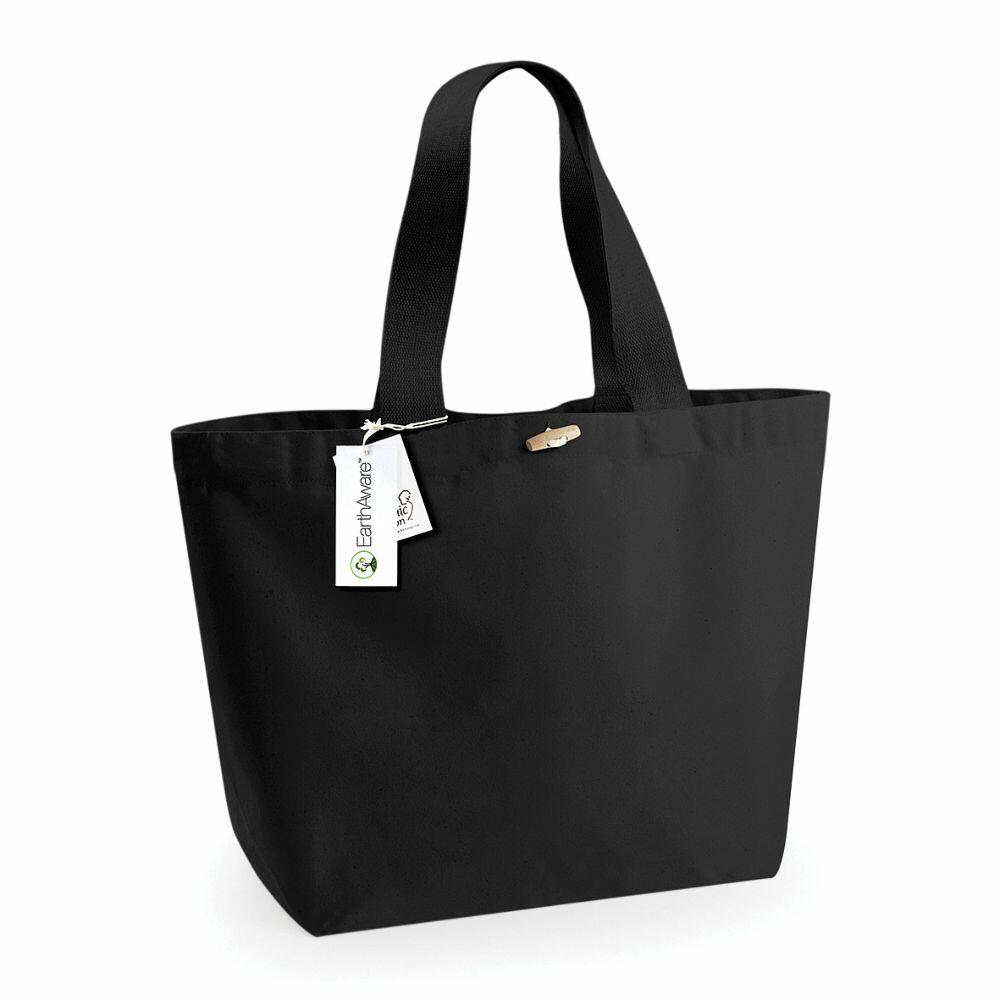 The WM855 black tote bag by Westford Mill features two handles and an attached white tag with a green logo.