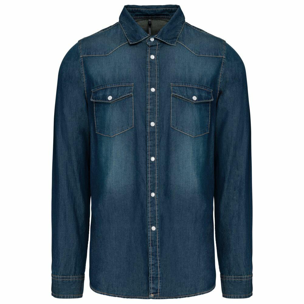 The Kariban KB519 is a dark blue denim shirt featuring long sleeves, a button front, and two chest pockets.