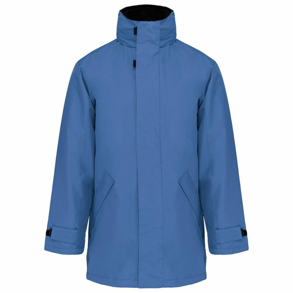 The Kariban KB677 is a blue winter jacket featuring a high collar and full sleeves. It includes a front zipper concealed by a flap, Velcro adjustable cuffs, and two diagonal pockets on the front.