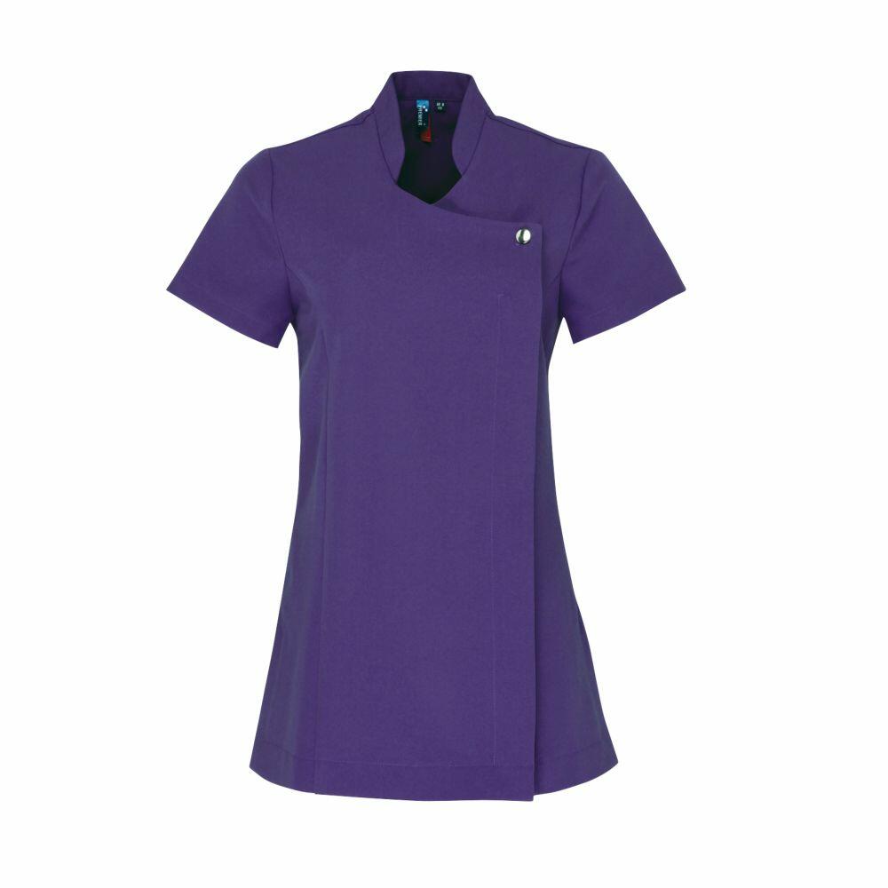 The Premier PR683 tunic is a short-sleeved, purple top featuring an asymmetrical front design and a single button closure near the collar, offering a professional and clean appearance.