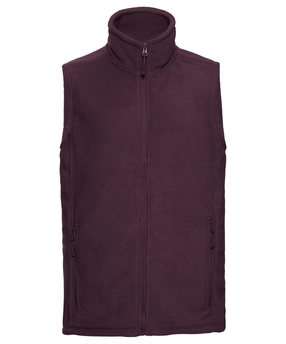 A sleeveless fleece vest known as the 8720M by Russell is featured in deep purple with a front zipper. It includes a high collar and two zippered pockets, displayed against a plain white background.
