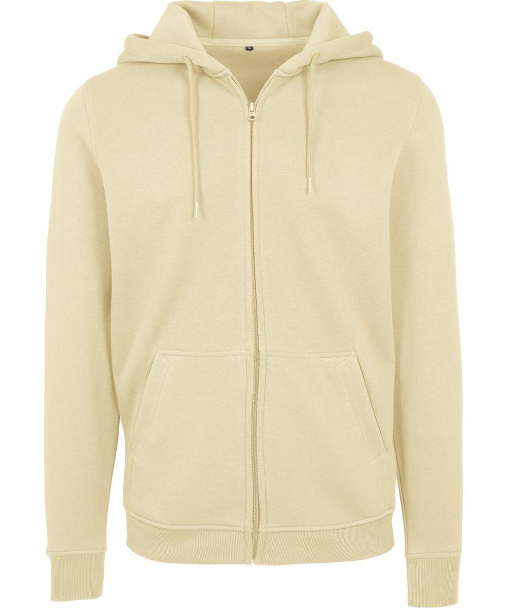 The BY012 by Build Your Brand is a beige zip-up hoodie featuring a hood with drawstrings and front pockets. It is crafted from soft, comfortable fabric, making it ideal for casual wear.