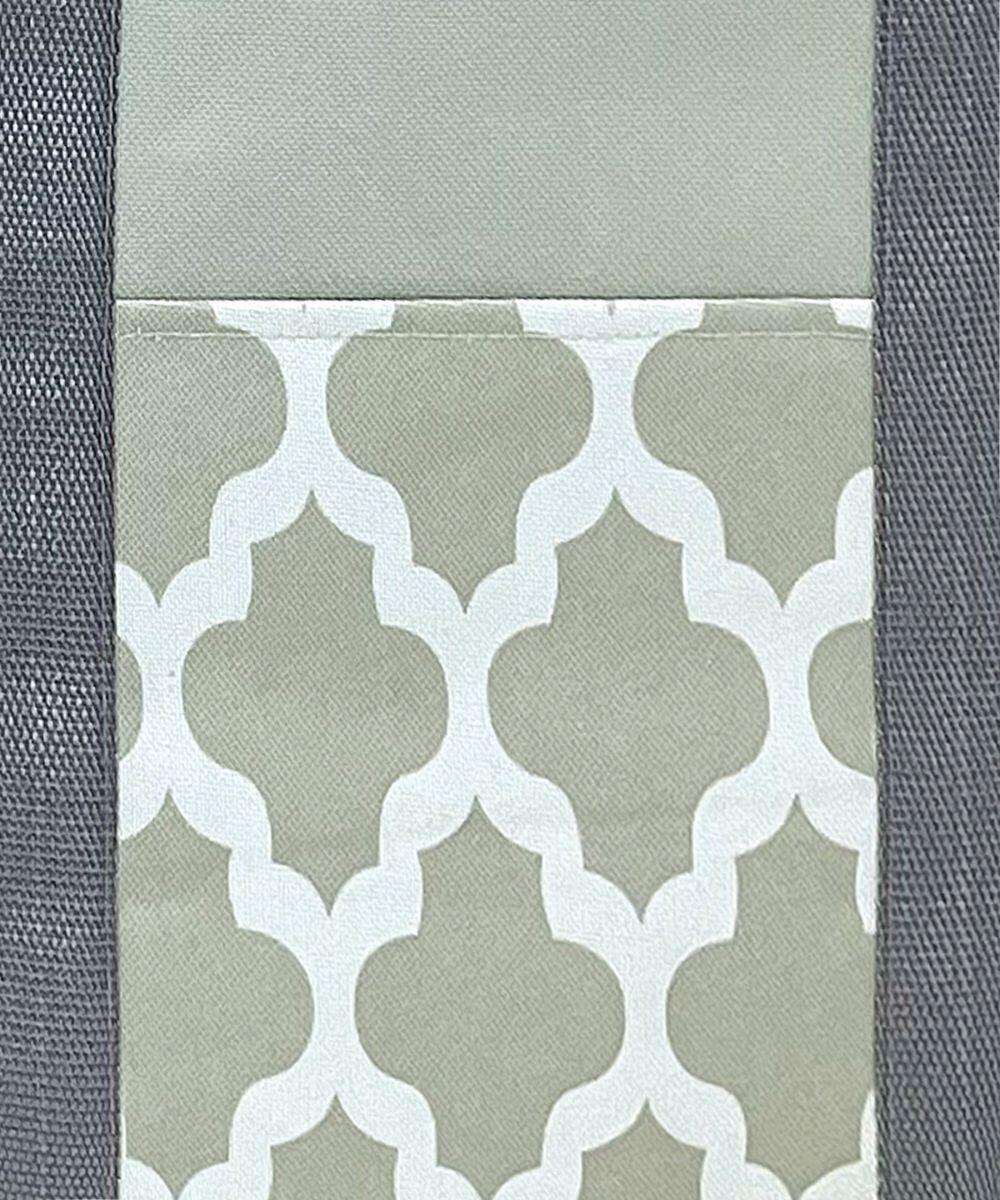 The HL204 from Home & Living features a geometric pattern with a white quatrefoil design on a light gray background, framed by darker gray textured fabric.