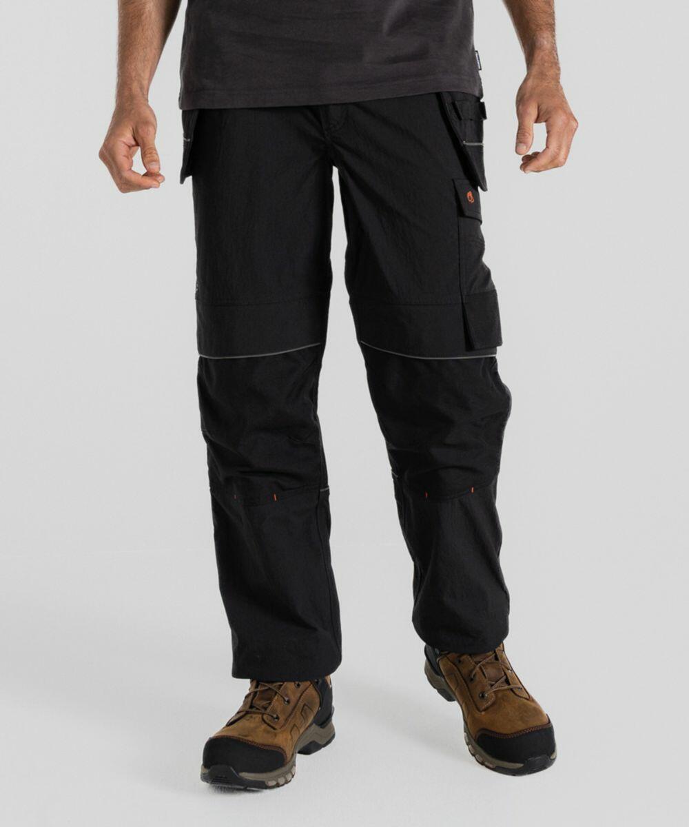 A person wearing black Craghoppers CR705 cargo pants and brown hiking boots stands with hands slightly at their sides against a plain background.