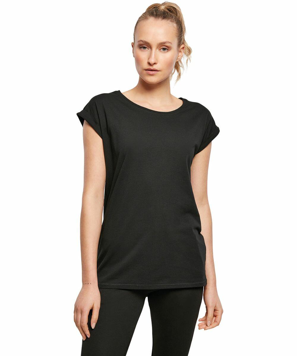 A woman wearing a plain black short-sleeve BY138 t-shirt from Build Your Brand and black pants stands against a white background.