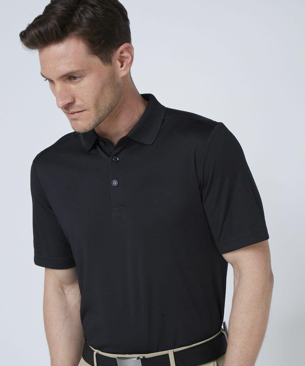 A man wearing a black Callaway CW032 polo shirt and beige pants stands against a plain background, looking down to his right.