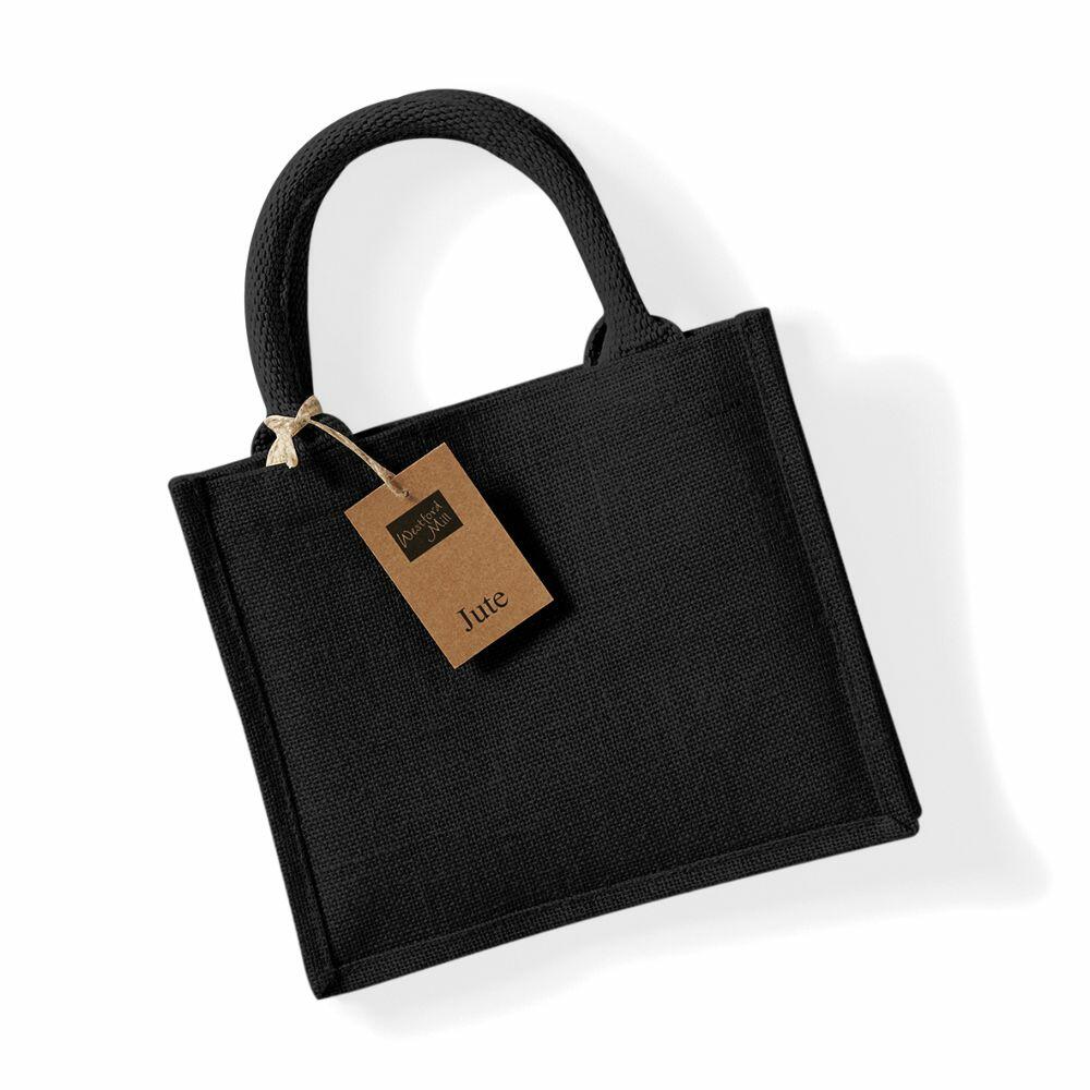 The Westford Mill WM412, a black jute tote bag with two handles and a brown tag attached, is placed on a white background.