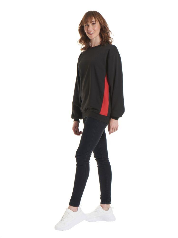 A women wearing a Uneek Two Tone Crew New Sweatshirt in Black with Red detailing