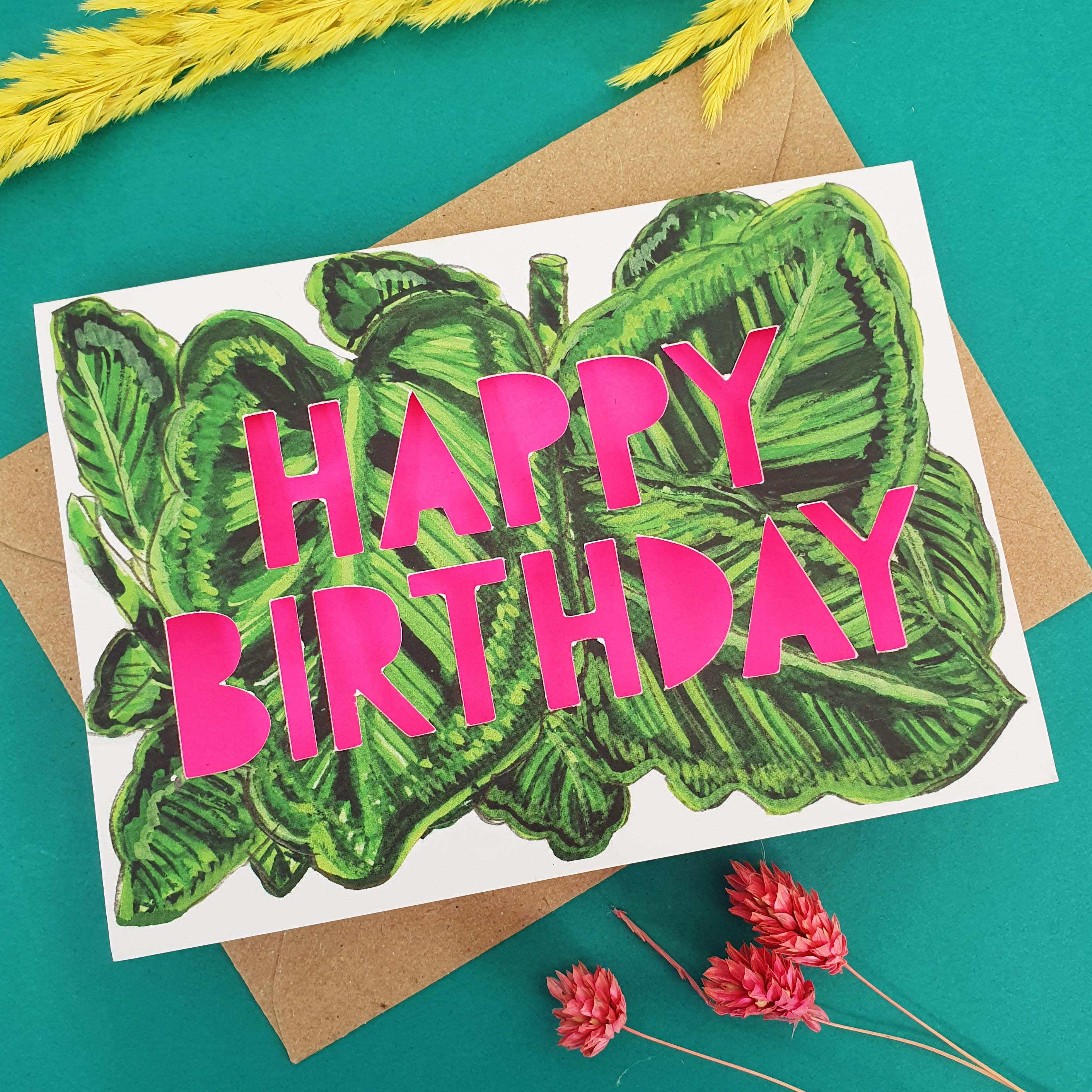 Close up of paper cut card with 'Happy Birthday' typography on a printed spotty begonia 350 gsm card with neon pink iner.