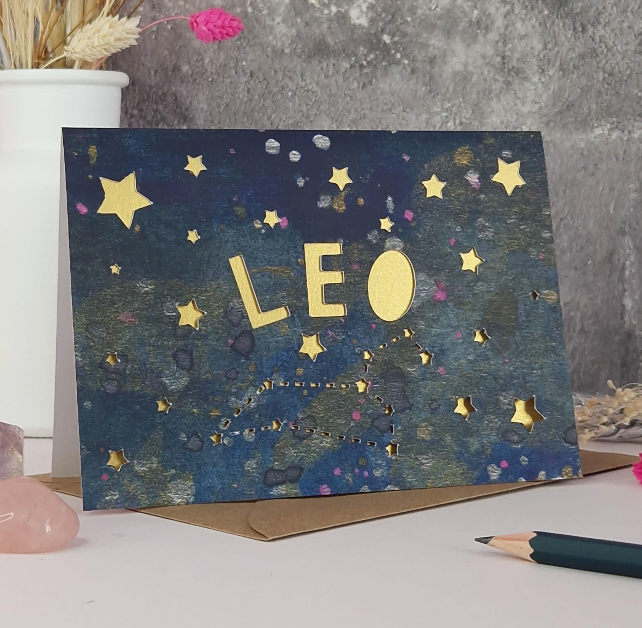 Midnight Blue printed card with papercut text that says 'Leo' and a mink pearl liner