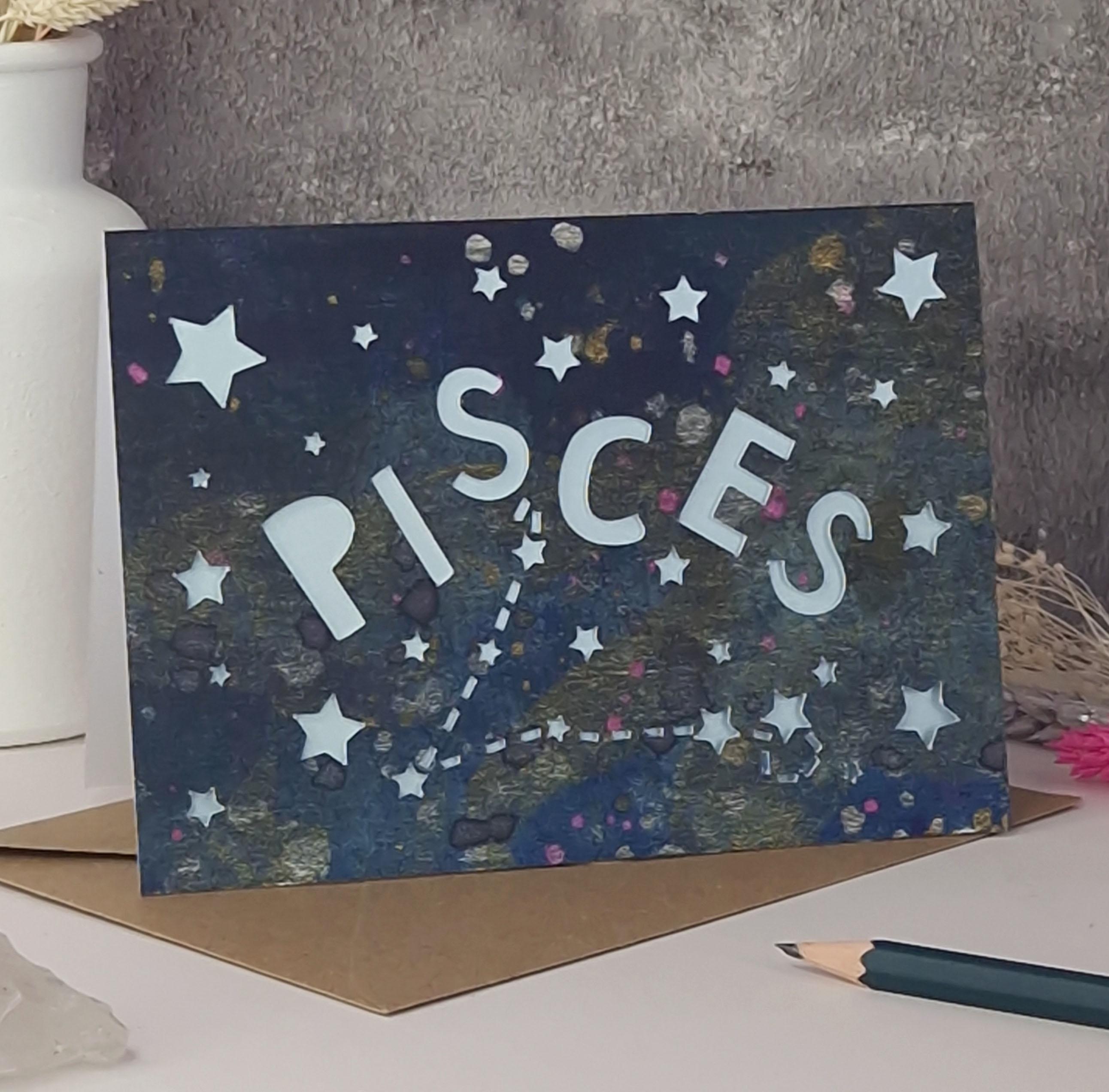 Midnight Blue printed card with papercut text that says 'Pisces' and a light blue pearl liner