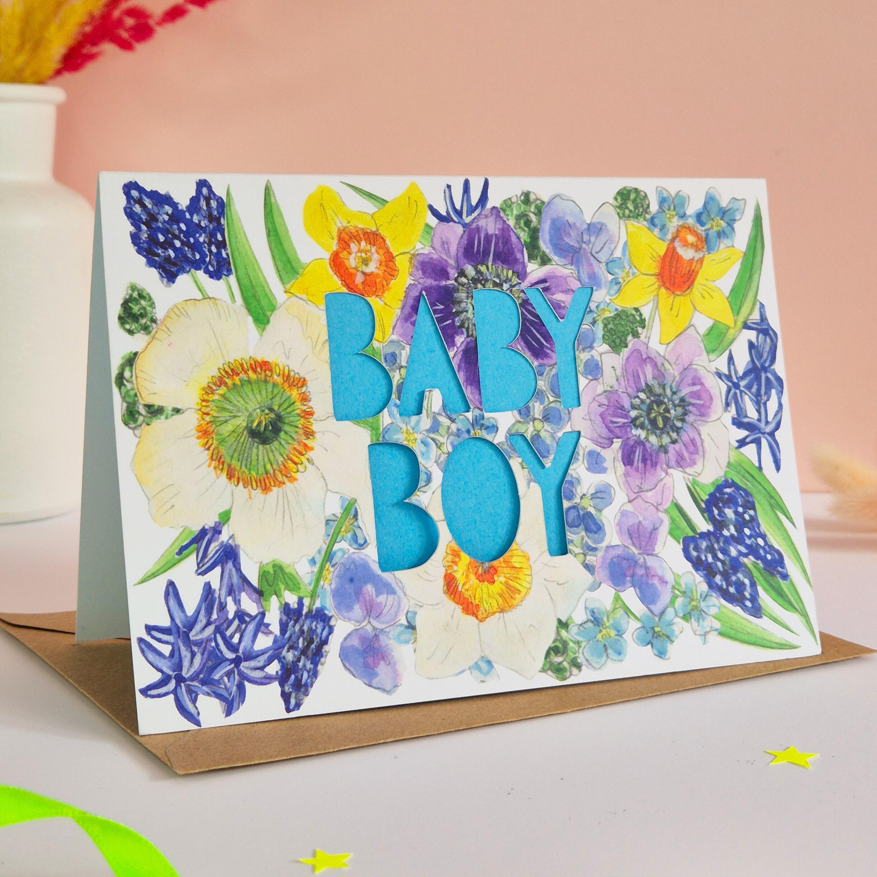 Floral Illustration card with die cut Baby Boy text and bright blue paper liner