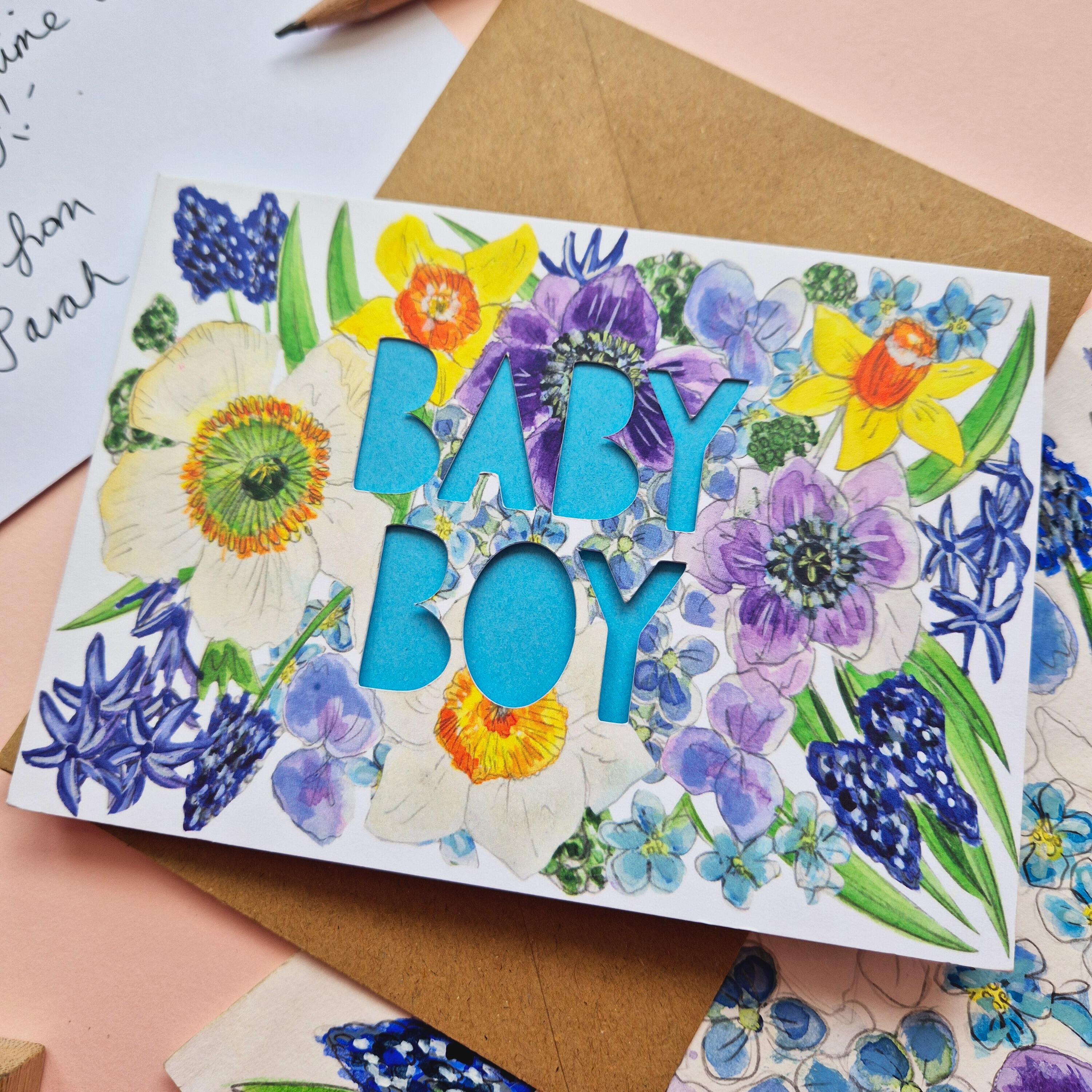 Floral Illustration card with die cut Baby Boy text and bright blue paper liner